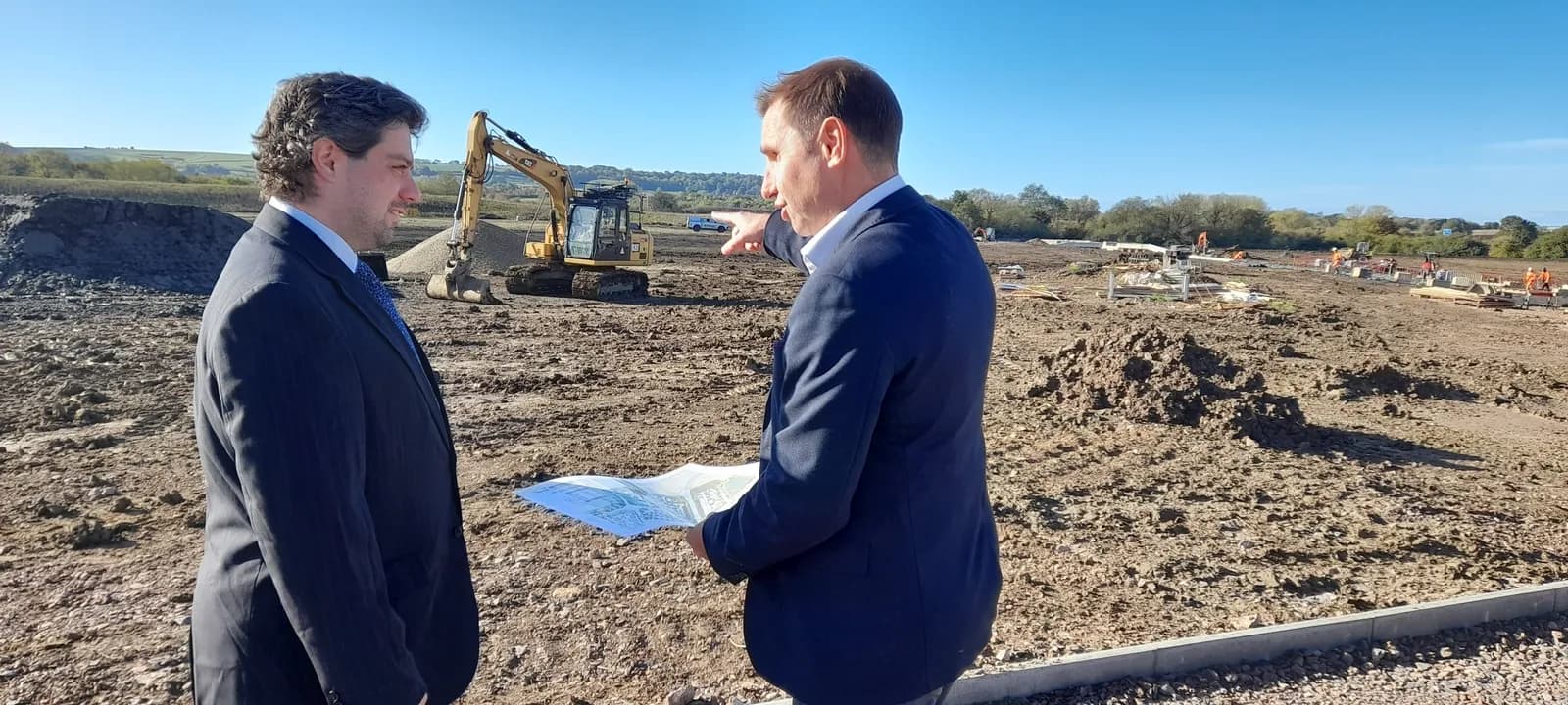 Russell Glimstead, Barratt Redrow Regional Managing Director for the West region and Wichelstowe LLP Board Chair showing plans for the next phase of the Wichelstowe development to Councillor Matty Cou